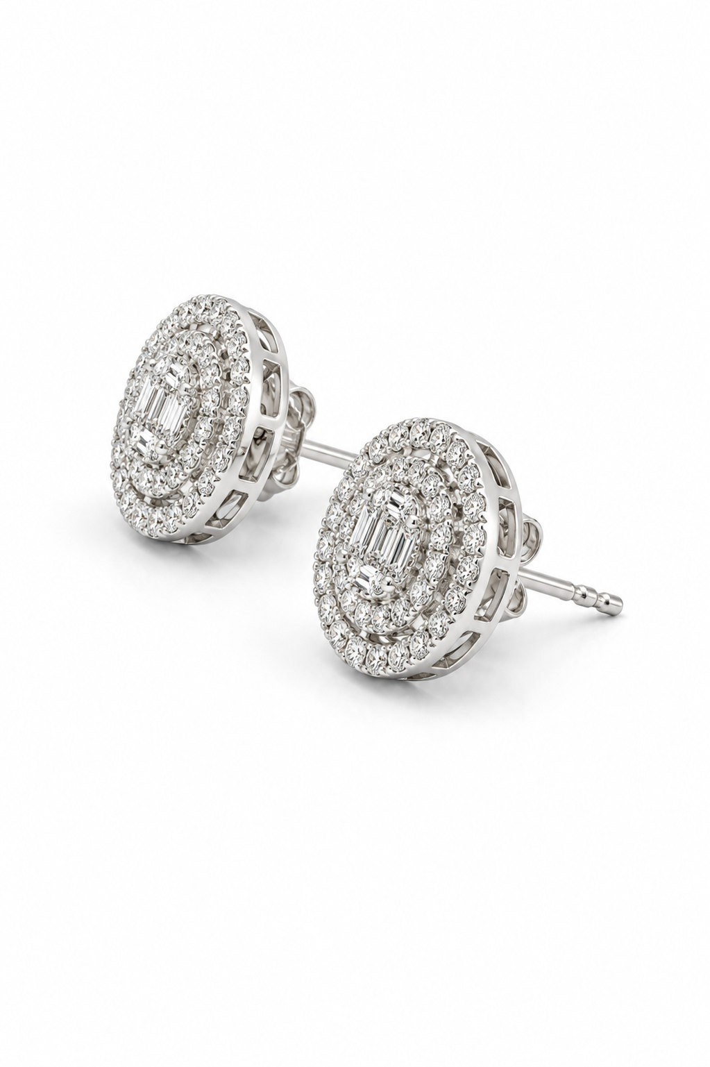A pair of oval diamond stud earrings in a silver-toned setting, featuring a halo of small diamonds around an emerald-cut center stone, shown on a clean white background.
