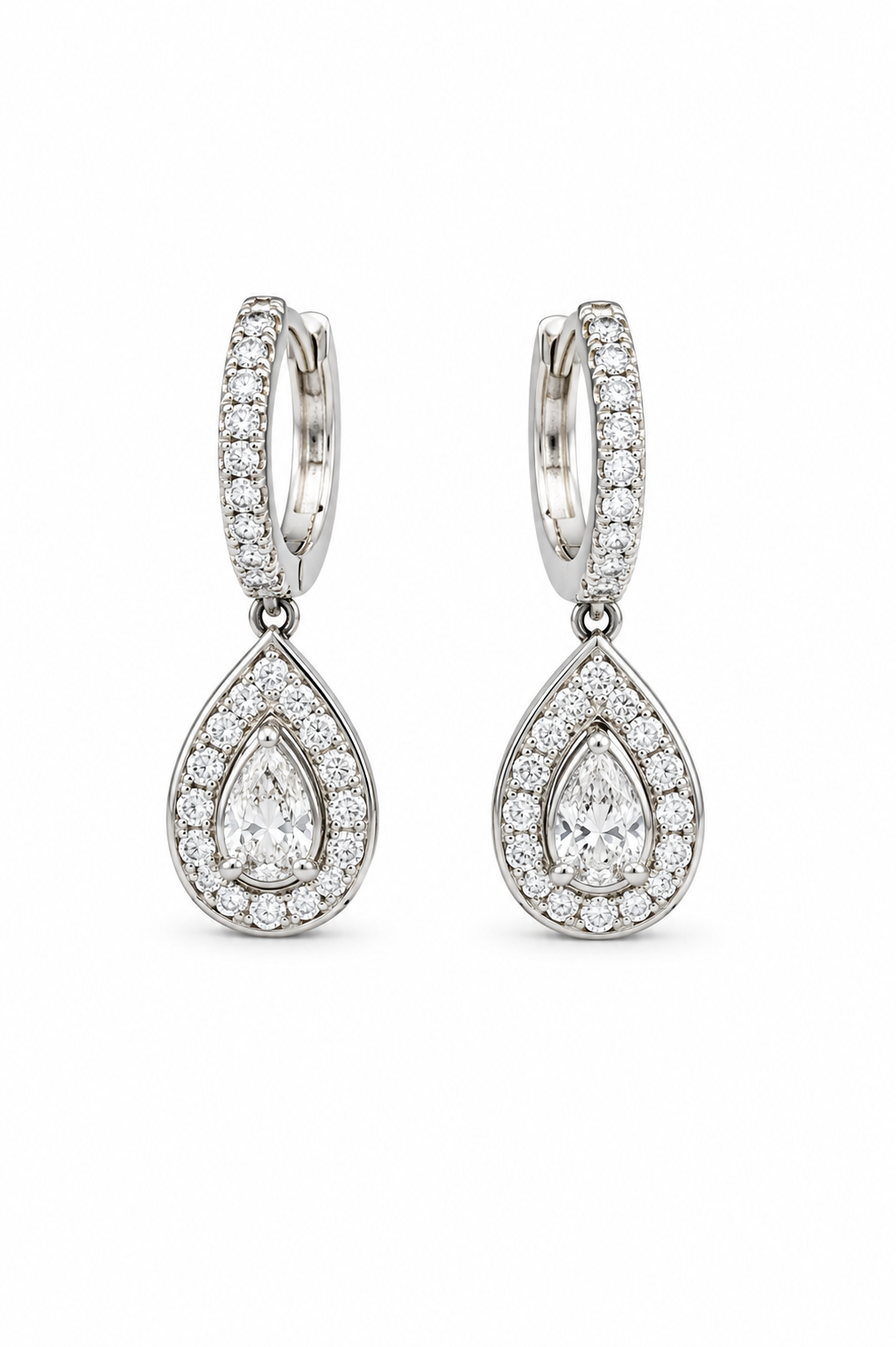 A pair of silver-tone huggie hoop earrings with teardrop-shaped drops, both adorned with pavé-set round and pear-cut clear gemstones, shown on a plain white background.