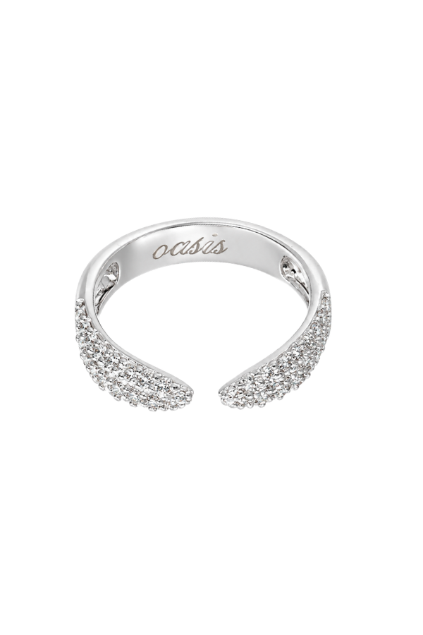 A silver-toned open ring band featuring pavé-set clear stones on both curved ends, with the brand name 'oasis' engraved inside. The ring is photographed on a seamless white background.