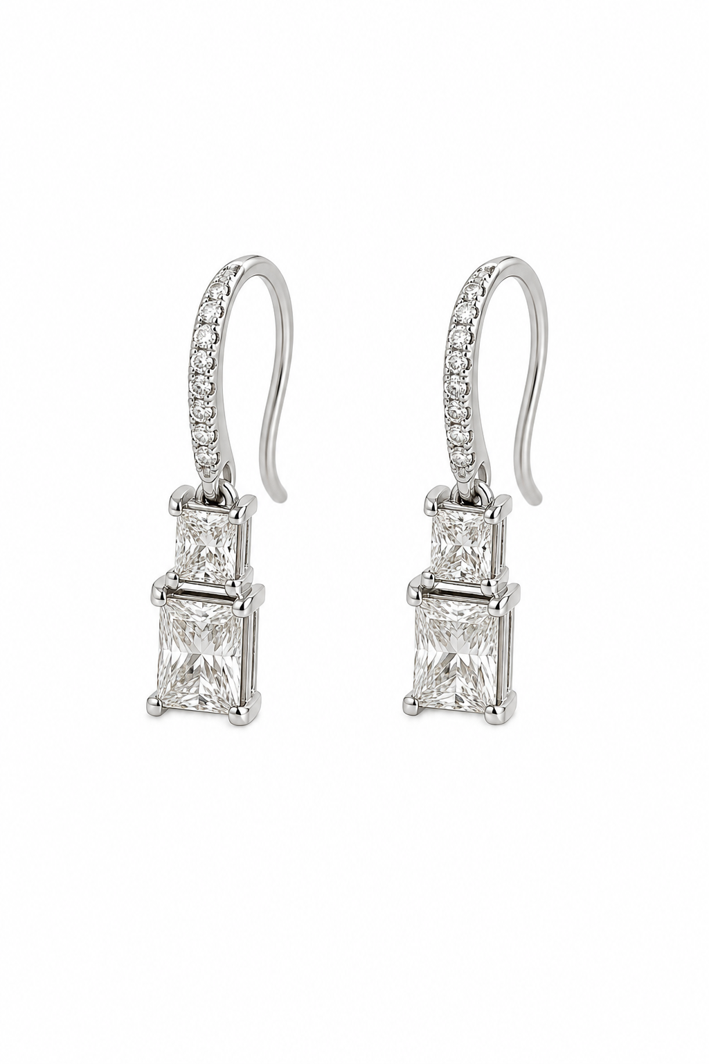 A pair of silver drop earrings featuring rectangular princess-cut diamonds and a pavé band of small round diamonds on curved hooks, set against a plain white background.
