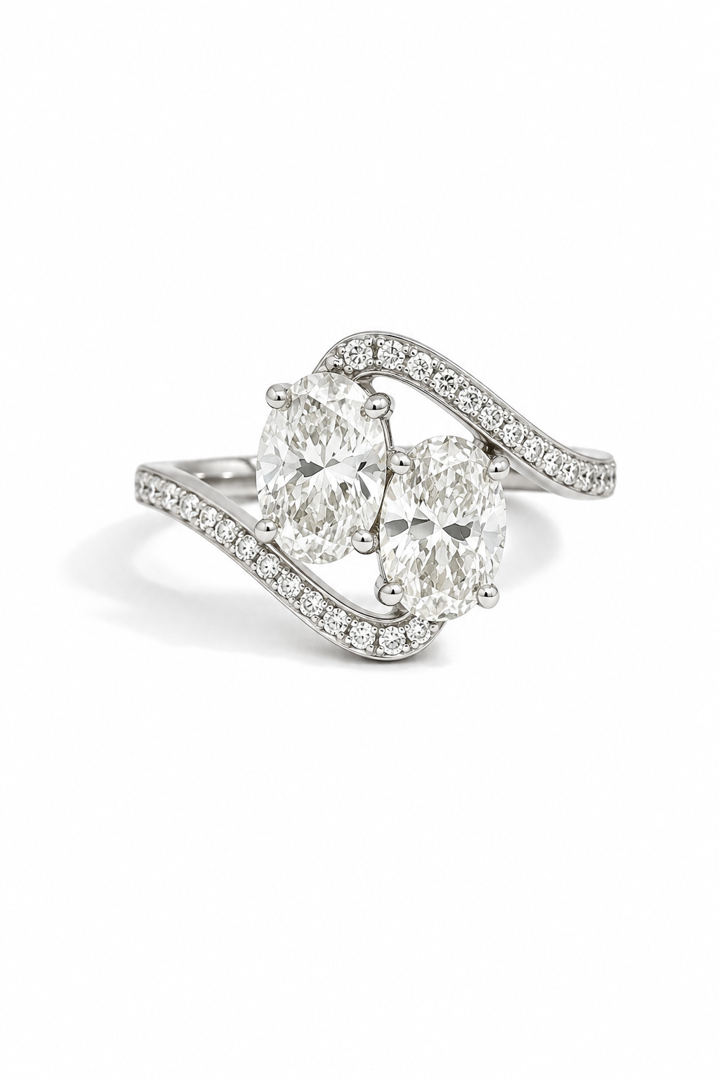 A silver-toned diamond ring featuring two oval-cut center stones and a curved pavé band, photographed on a clean white background.