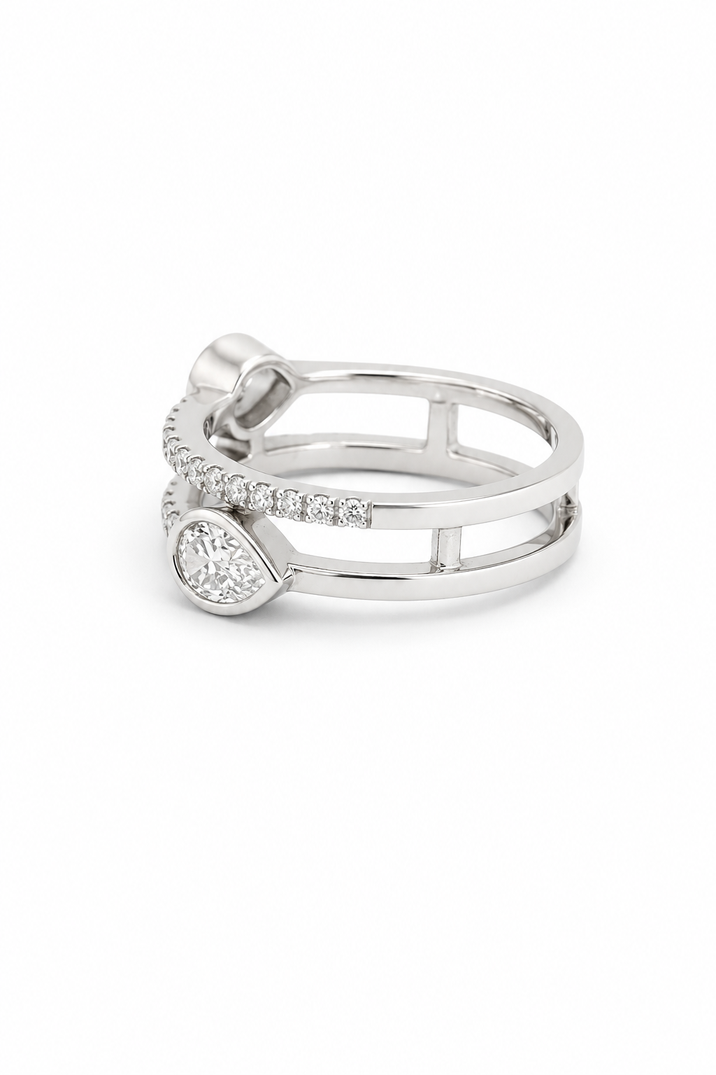 A silver-toned double-band ring featuring a pavé-set row of small clear stones and a teardrop-shaped clear gemstone on the front, photographed on a clean white background.