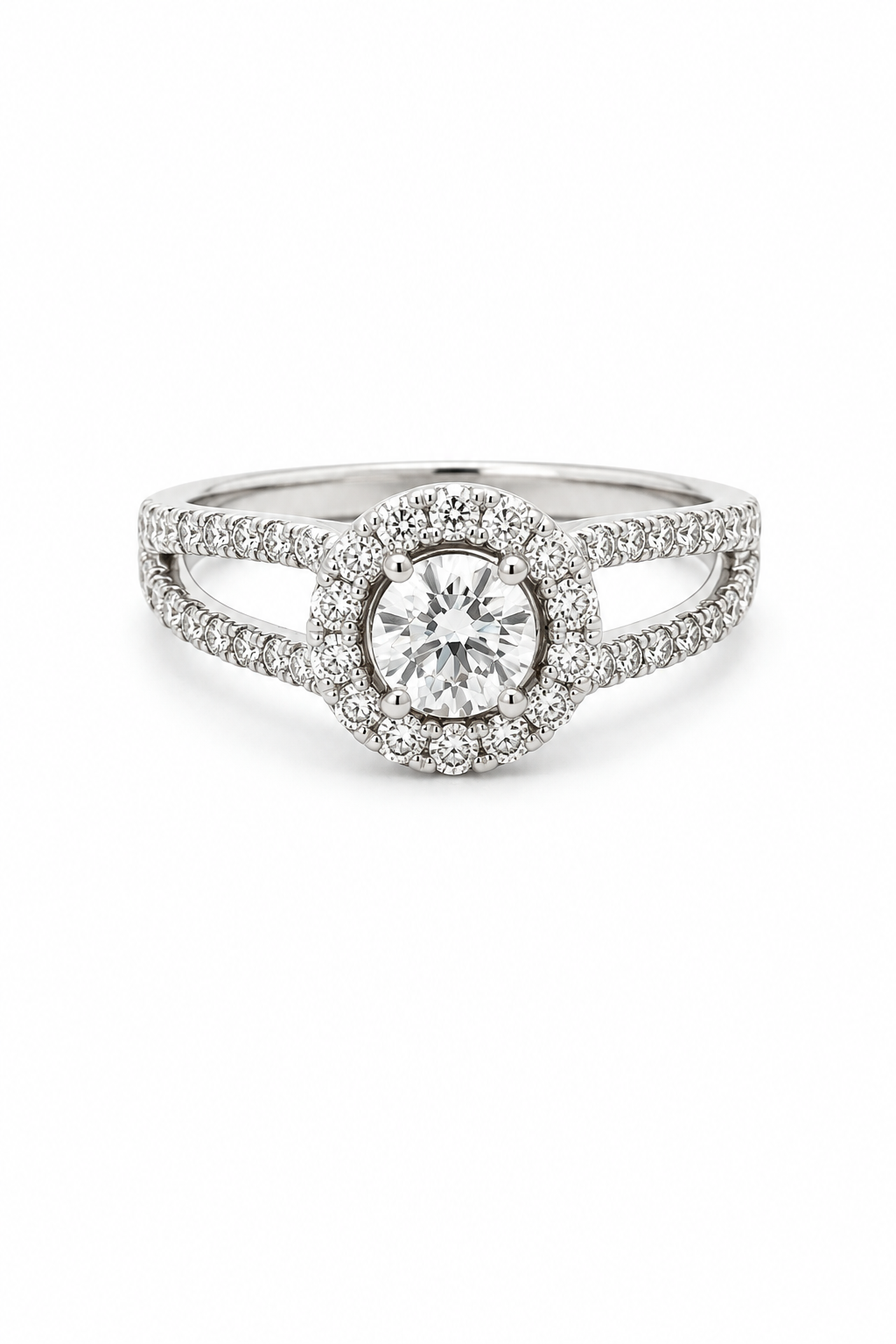 A silver-toned halo ring featuring a round-cut center stone surrounded by a double halo of smaller stones, with a split shank also paved with stones, shown on a plain white background-The Whisper Ring, Mioraahs, Lab Grown Diamonds, inspired and locally designed out of New York City